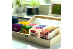 Image Wooden box filled with assorted colorful tea bags from various brands